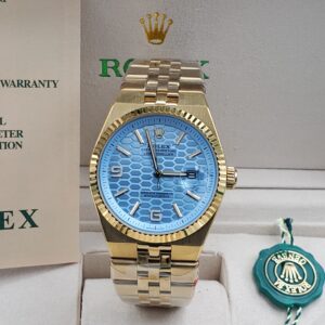 Rolex Oyster Perpetual Land-Dweller in gold with a blue honeycomb dial and Jubilee bracelet.